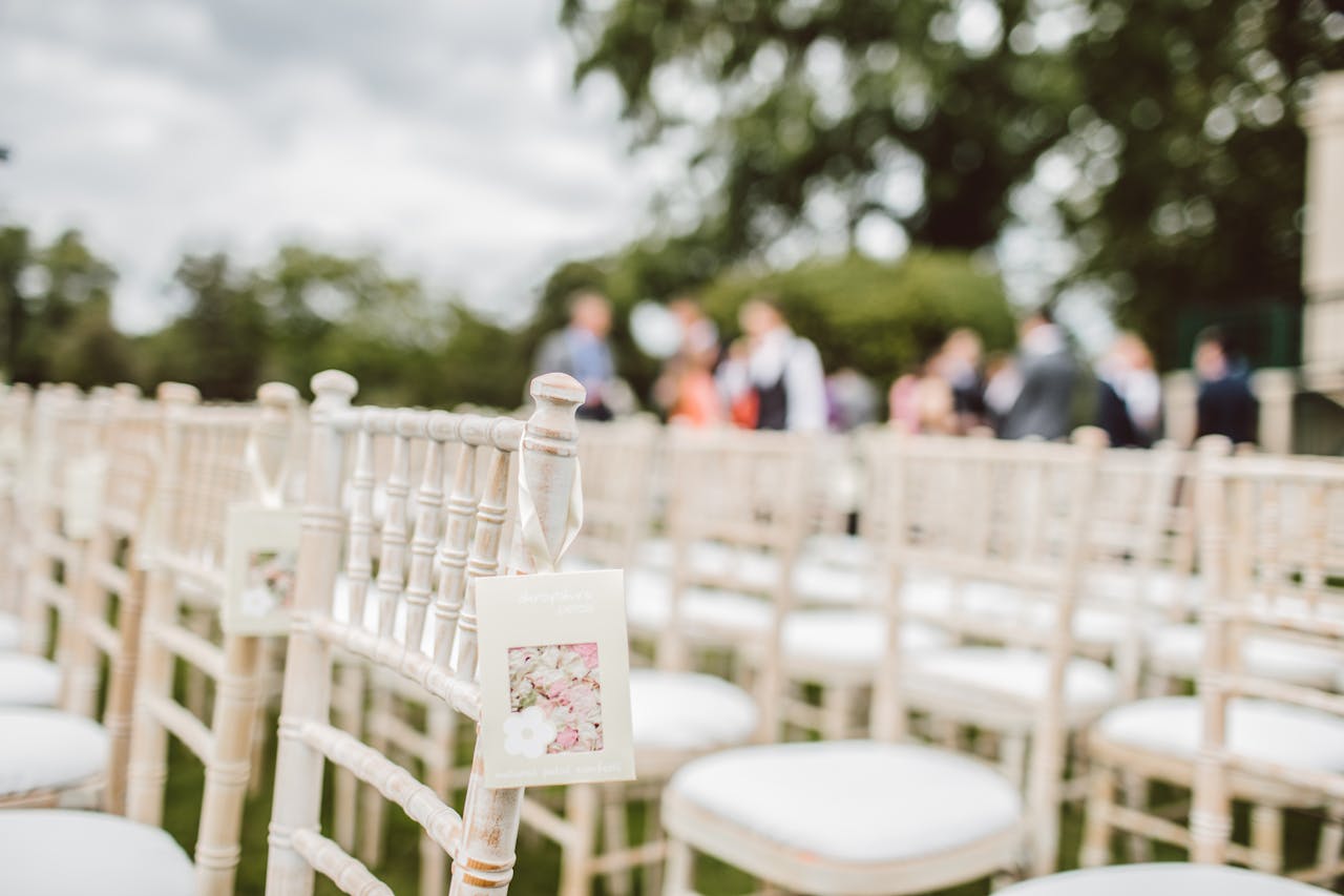 Mastering the First Impression: Your intriguing post title goes here Elegant outdoor wedding setup with wooden chairs and blurred background.