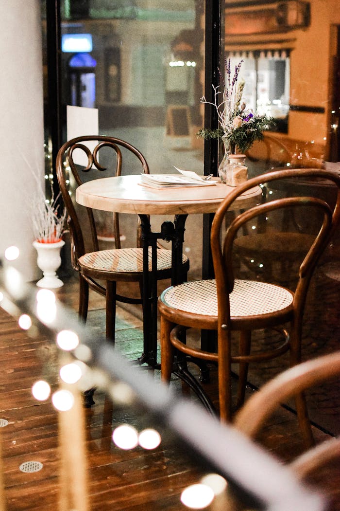 Elegant café setting with classic wooden chairs and a round table, offering a warm atmosphere.